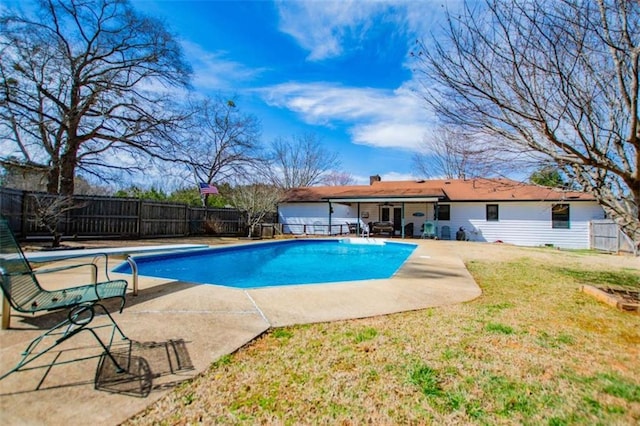 view of swimming pool with a fenced in pool, a lawn, a patio area, a fenced backyard, and a diving board