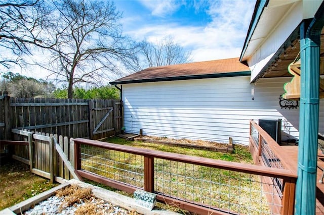 view of home's exterior with a gate and fence