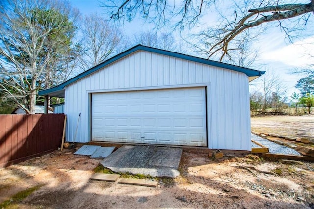 detached garage featuring fence