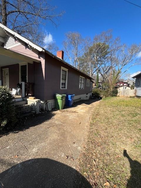 view of side of property with a yard