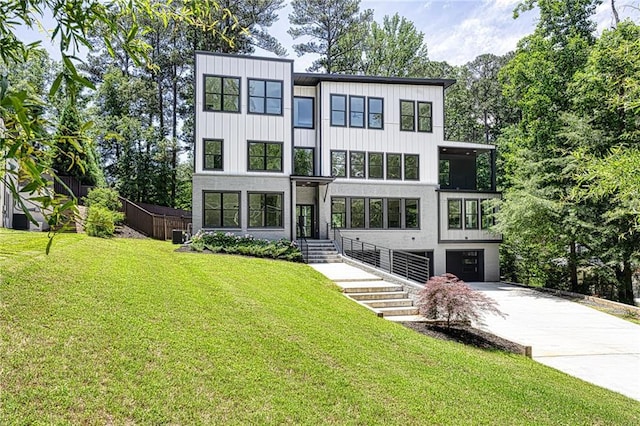 2110 Fairway Cir NE, Brookhaven, GA 30319 - modern home featuring concrete driveway and a garage