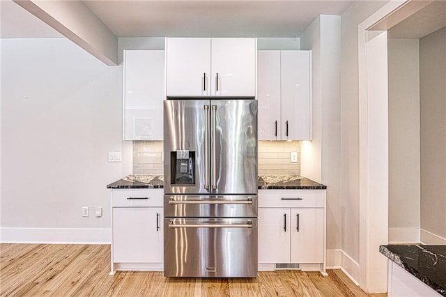 2110 Fairway Cir NE, Brookhaven, GA 30319 - kitchen with stainless steel refrigerator with ice dispenser, light wood-style flooring, backsplash, white cabinetry, and dark stone counters