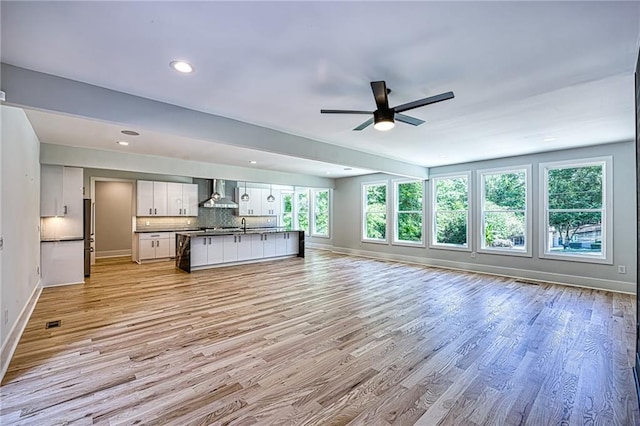 2110 Fairway Cir NE, Brookhaven, GA 30319 - kitchen with open floor plan, wall chimney range hood, baseboards, ceiling fan, and light wood-style flooring