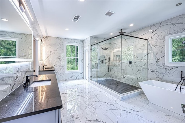 2110 Fairway Cir NE, Brookhaven, GA 30319 - bathroom with stone wall, marble tiled flooring, recessed lighting, a marble finish shower, and vanity
