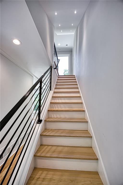 2110 Fairway Cir NE, Brookhaven, GA 30319 - staircase with wood finished floors and recessed lighting