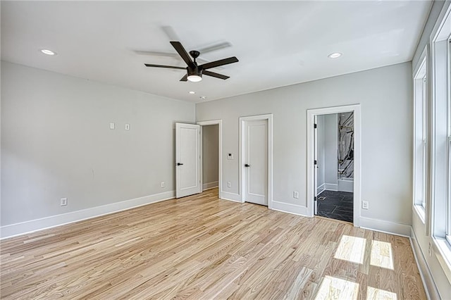 2110 Fairway Cir NE, Brookhaven, GA 30319 - unfurnished bedroom featuring light wood finished floors, baseboards, ensuite bathroom, multiple windows, and recessed lighting