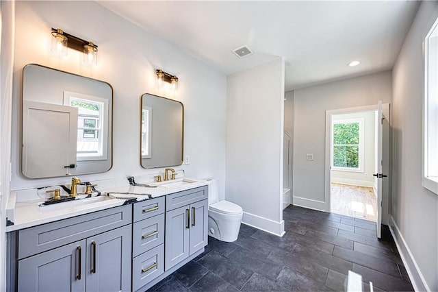 2110 Fairway Cir NE, Brookhaven, GA 30319 - bathroom featuring toilet, baseboards, double vanity, and recessed lighting