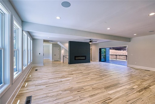 2110 Fairway Cir NE, Brookhaven, GA 30319 - unfurnished living room featuring a large fireplace, ceiling fan, light wood-style flooring, baseboards, and recessed lighting