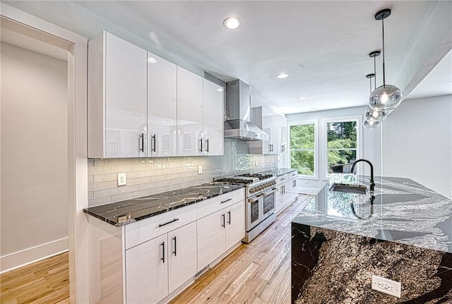 2110 Fairway Cir NE, Brookhaven, GA 30319 - kitchen with wall chimney exhaust hood, range with two ovens, a sink, light wood-style flooring, and recessed lighting