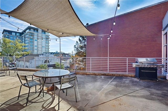 view of patio featuring a balcony and grilling area