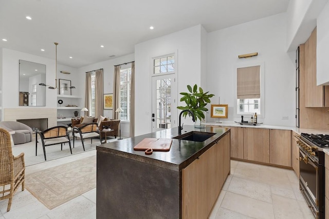 11273 Serenbe Ln, Chattahoochee Hills, GA 30268 - kitchen featuring sink, a kitchen island with sink, light tile flooring, and gas range