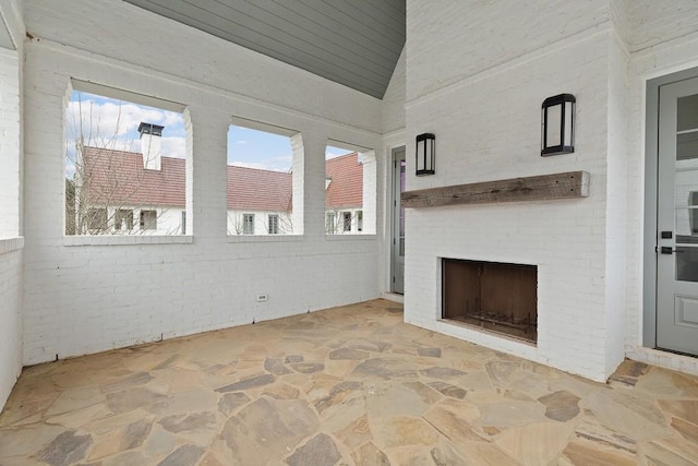 11273 Serenbe Ln, Chattahoochee Hills, GA 30268 - unfurnished living room featuring a healthy amount of sunlight and a fireplace