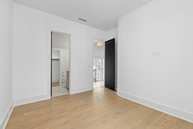 11273 Serenbe Ln, Chattahoochee Hills, GA 30268 - unfurnished bedroom featuring connected bathroom and light hardwood / wood-style flooring