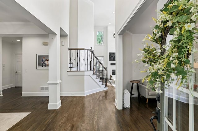 4944 Dovecote Trl, Suwanee, GA 30024 - entrance foyer featuring wood finished floors, stairway, decorative columns, recessed lighting, and crown molding