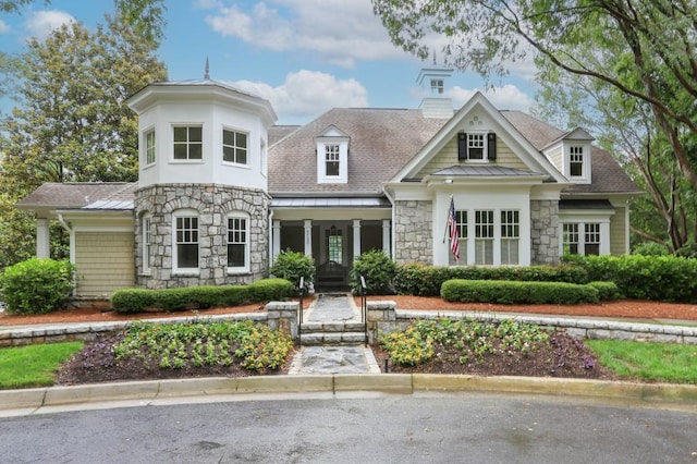 4944 Dovecote Trl, Suwanee, GA 30024 - view of front facade featuring stone siding, a chimney, roof with shingles, and a standing seam roof