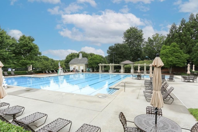 4944 Dovecote Trl, Suwanee, GA 30024 - community pool featuring view of wooded area and a patio