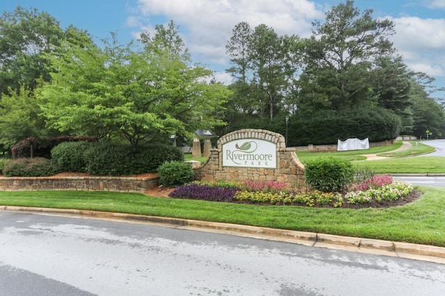 4944 Dovecote Trl, Suwanee, GA 30024 - community / neighborhood sign featuring a lawn and view of wooded area