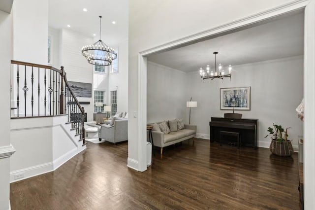 4944 Dovecote Trl, Suwanee, GA 30024 - living area featuring a chandelier, stairs, wood finished floors, recessed lighting, and crown molding