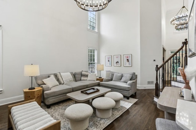 4944 Dovecote Trl, Suwanee, GA 30024 - living room with a chandelier, a high ceiling, dark wood-style floors, and stairs