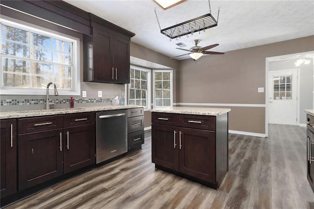 kitchen with decorative backsplash, a ceiling fan, dishwasher, wood finished floors, and a sink