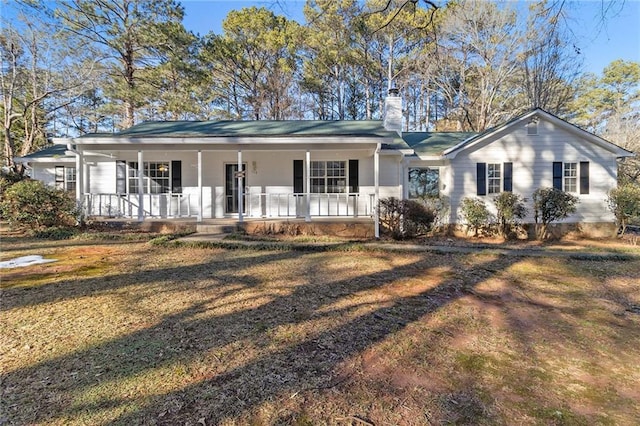 ranch-style home with covered porch and a chimney