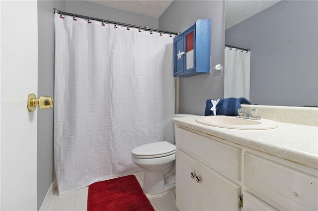 bathroom with tile patterned floors, a textured ceiling, toilet, and vanity