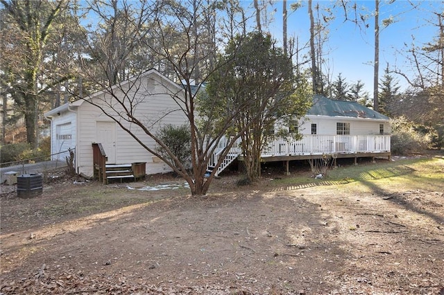 back of property featuring a garage, cooling unit, a deck, and entry steps