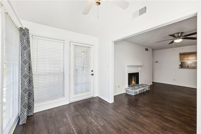 unfurnished living room with ceiling fan and dark hardwood / wood-style floors