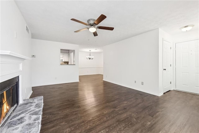 unfurnished living room with dark hardwood / wood-style floors and ceiling fan with notable chandelier