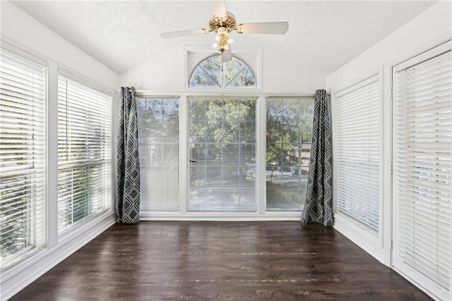 unfurnished sunroom with ceiling fan and vaulted ceiling