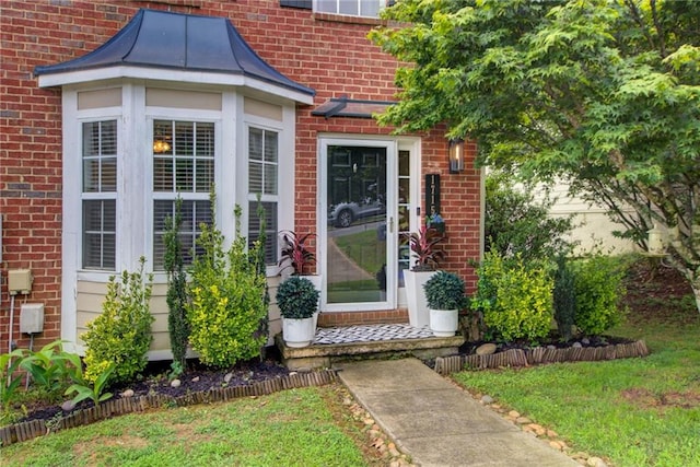 entrance to property with a lawn