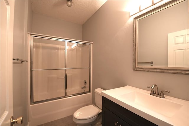 full bathroom with vanity, toilet, bath / shower combo with glass door, and a textured ceiling