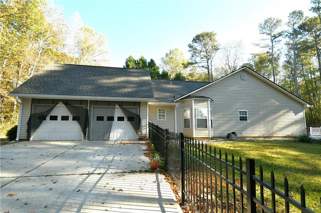 ranch-style house with a garage and a front lawn