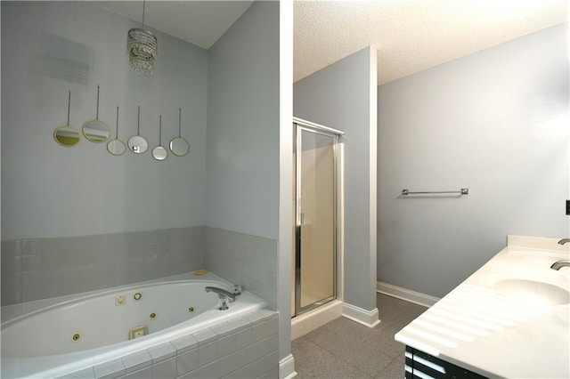 bathroom featuring vanity, shower with separate bathtub, and a textured ceiling