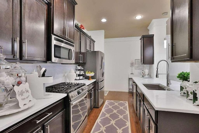 2626 Sardis Chase Ct, Buford, GA 30519 - kitchen featuring stainless steel appliances, dark brown cabinets, wood finished floors, light countertops, and recessed lighting