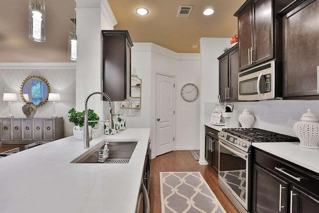 2626 Sardis Chase Ct, Buford, GA 30519 - kitchen featuring stainless steel appliances, light countertops, dark brown cabinetry, dark wood-style flooring, and recessed lighting