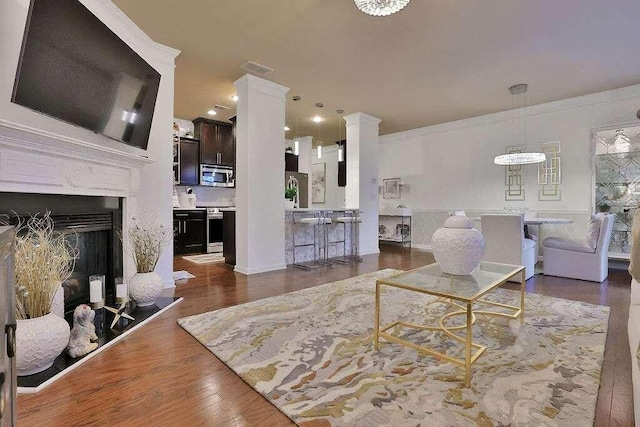 2626 Sardis Chase Ct, Buford, GA 30519 - living room featuring wood finished floors, ornate columns, and a fireplace with raised hearth