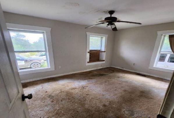 1705 Clifton St, Camden, AL 36726 - empty room featuring carpet, baseboards, and ceiling fan