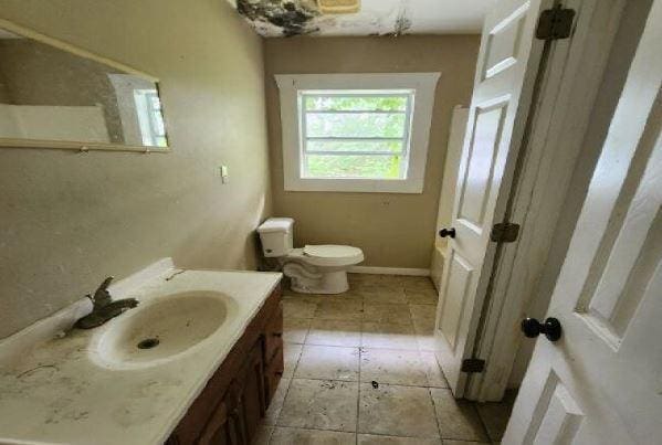 1705 Clifton St, Camden, AL 36726 - bathroom with toilet, vanity, tile patterned floors, and baseboards