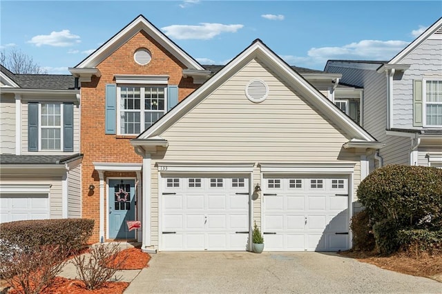 view of front of home featuring driveway and brick siding