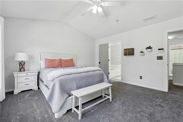 carpeted bedroom with visible vents, vaulted ceiling, ceiling fan, ensuite bath, and baseboards