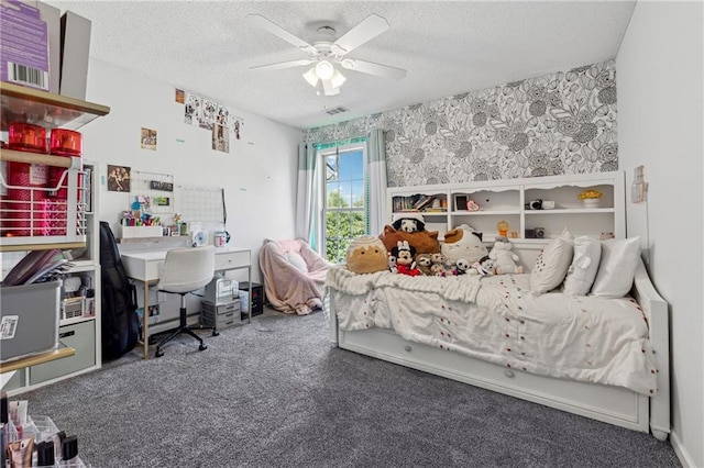 carpeted bedroom featuring visible vents, ceiling fan, a textured ceiling, and wallpapered walls