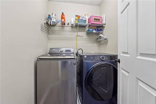 washroom featuring laundry area and washer and dryer