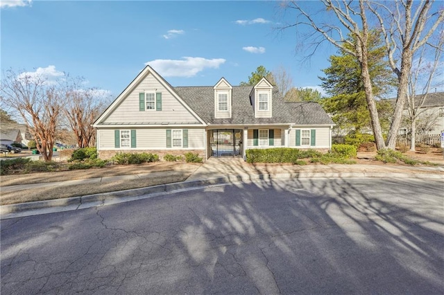 cape cod home with a shingled roof