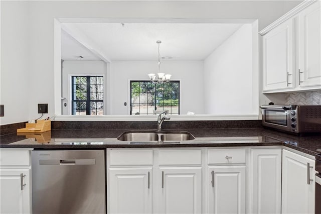 kitchen featuring a notable chandelier, a toaster, a sink, white cabinets, and stainless steel dishwasher