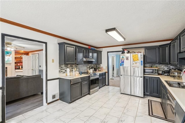 kitchen featuring stainless steel appliances, ornamental molding, sink, and backsplash