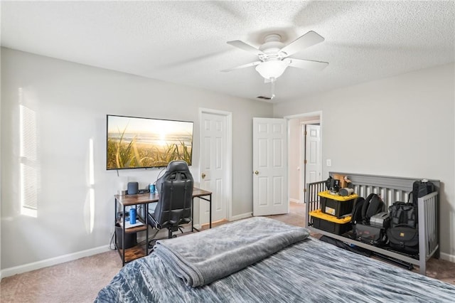 bedroom featuring ceiling fan, carpet floors, and a textured ceiling