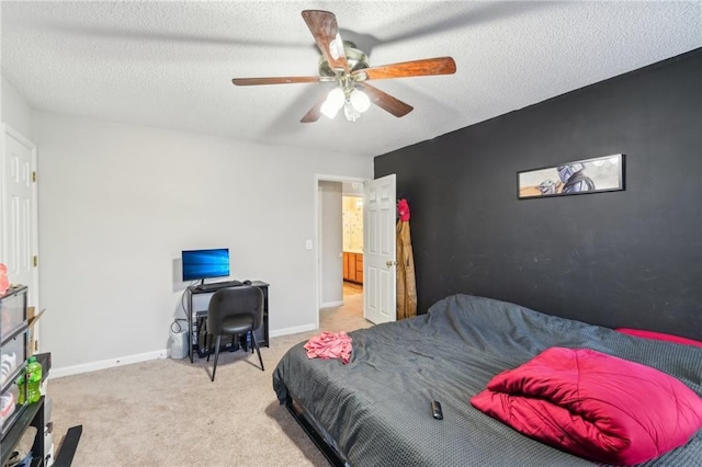 carpeted bedroom with ceiling fan and a textured ceiling