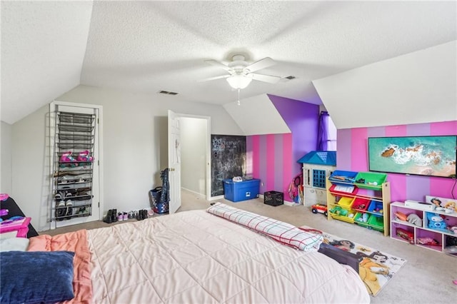 bedroom featuring lofted ceiling, light carpet, and a textured ceiling