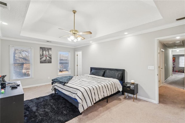 bedroom with a raised ceiling, ornamental molding, and light carpet